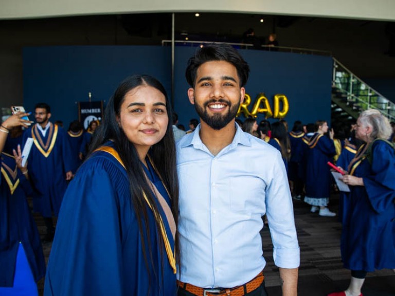 Graduate poses for photo with guest