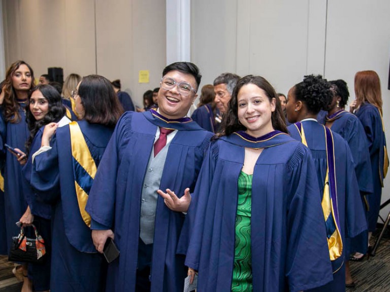 Graduates smile at camera