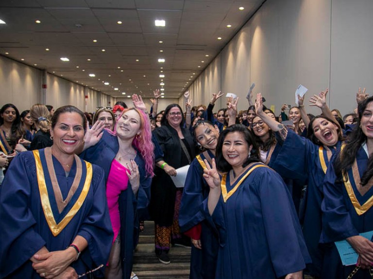 Graduates smile at camera