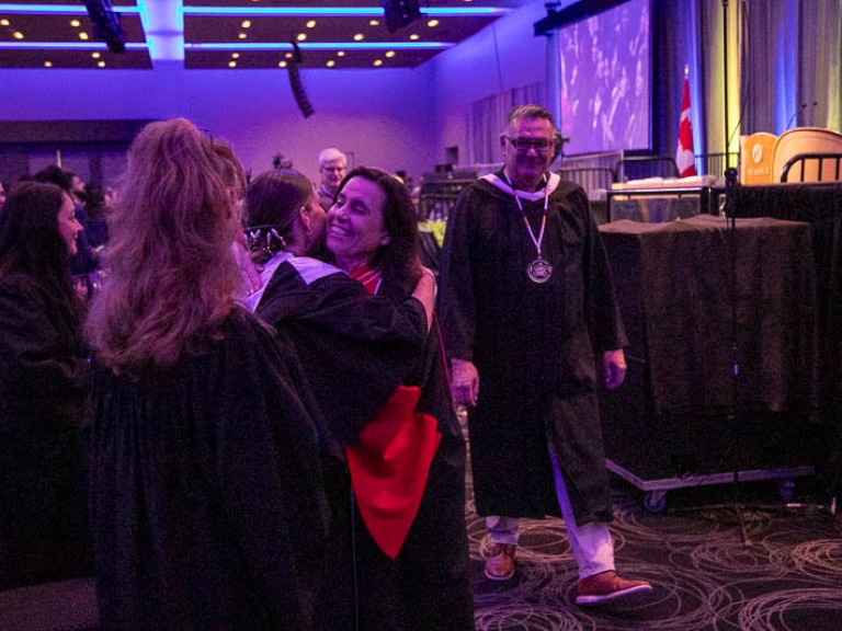 Humber faculty member hugs someone