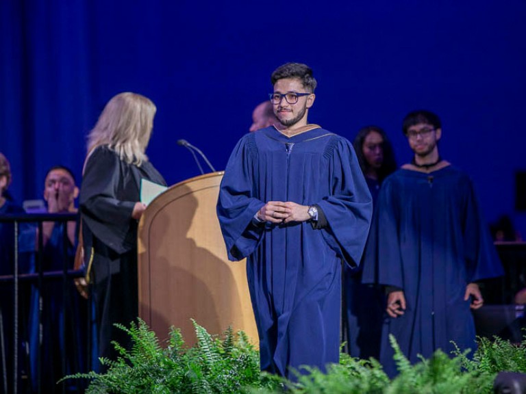 Graduate crosses stage