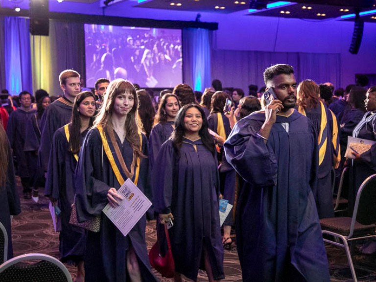 Graduates leave the ceremony hall