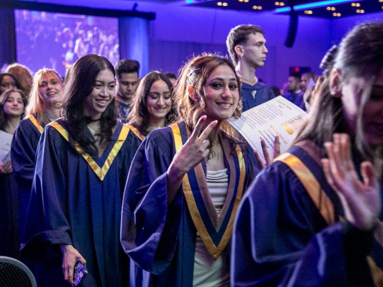 Graduates leave the ceremony hall