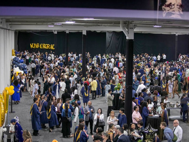 High angle view of graduates and guests mingling in the reception area