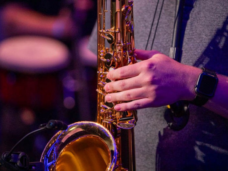 Person's hand on saxophone
