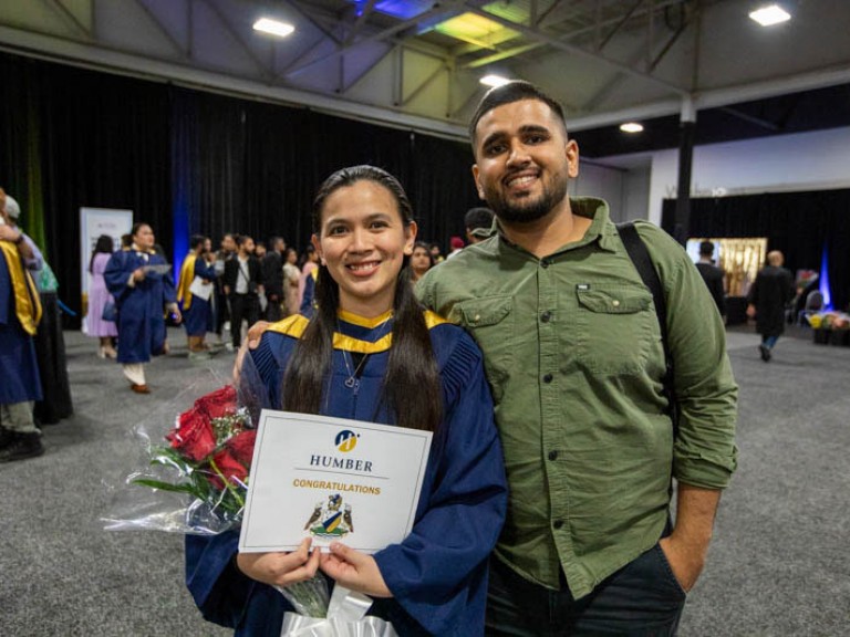 Graduate poses with guest