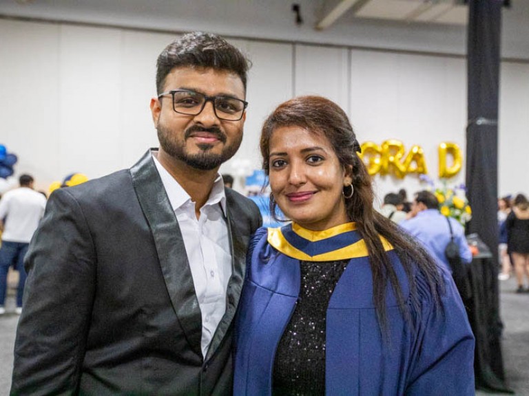 Graduate poses with guest