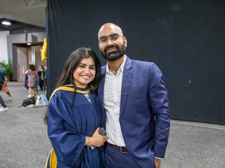 Graduate poses for photo with guest