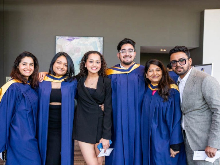 Four graduates and two guests pose for photo