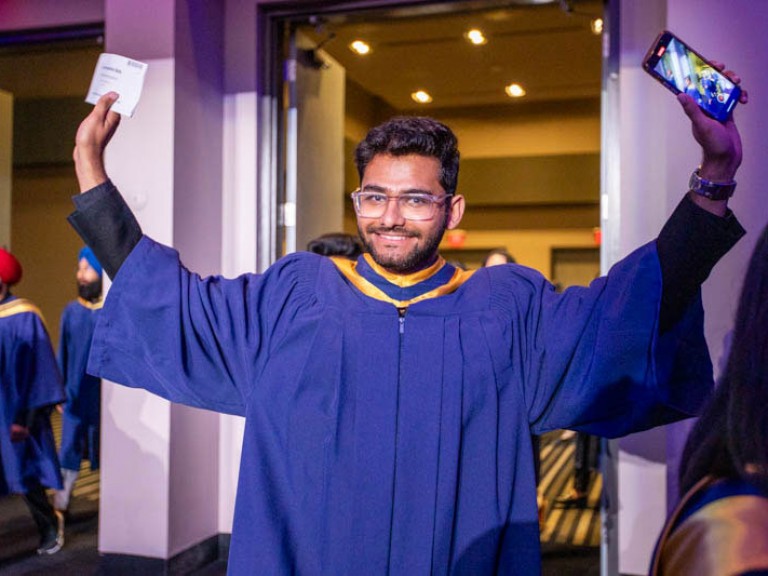 Graduate raises both arms