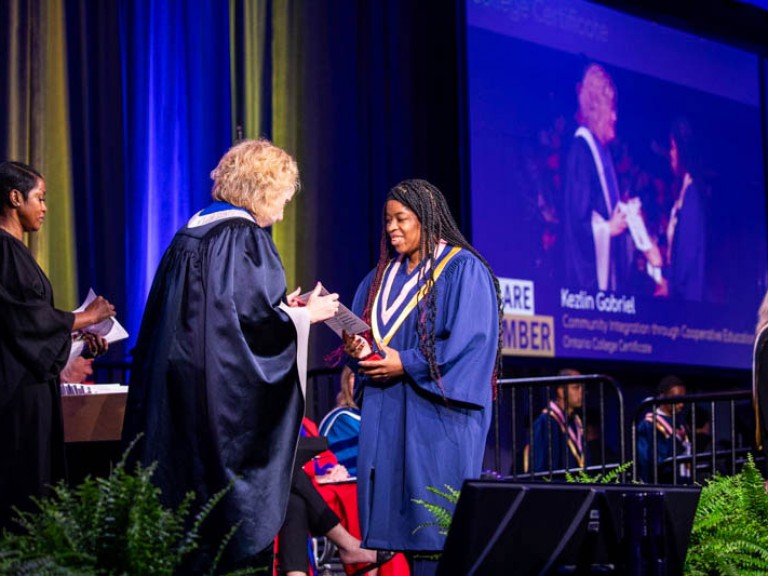 Graduate receives certificate from Humber president