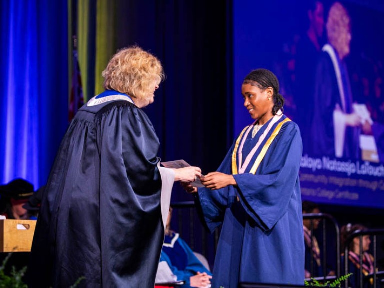 Graduate receives certificate from Humber president