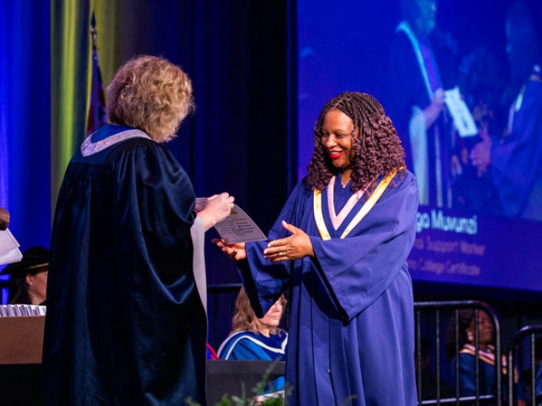 Graduate receives certificate from Humber president