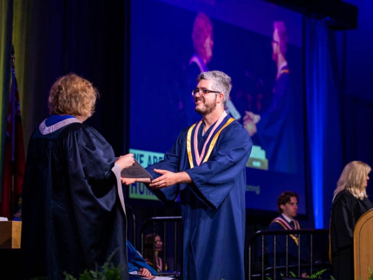 Graduate receives certificate from Humber president