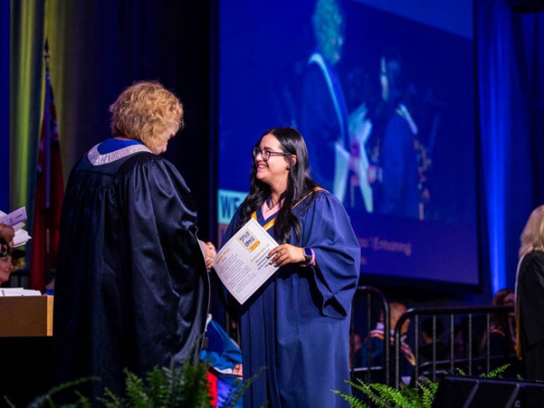 Graduate shakes Humber president's hand on stage