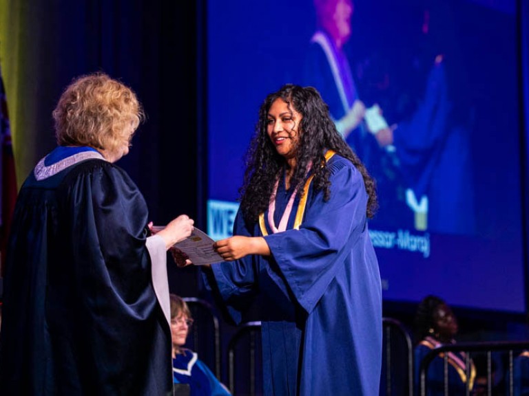 Graduate receives certificate from Humber president