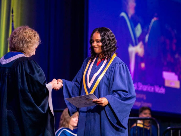Graduate shakes Humber president's hand on stage