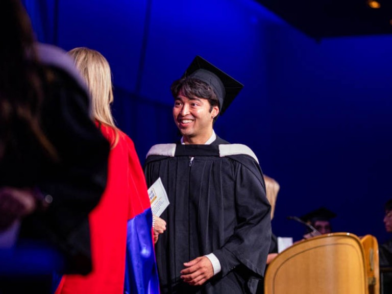 Graduate wearing cap smiling