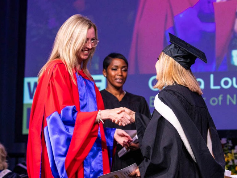 Graduate shaking hand of Humber faculty member