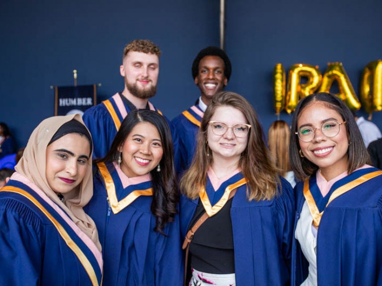 Six graduates pose for photo