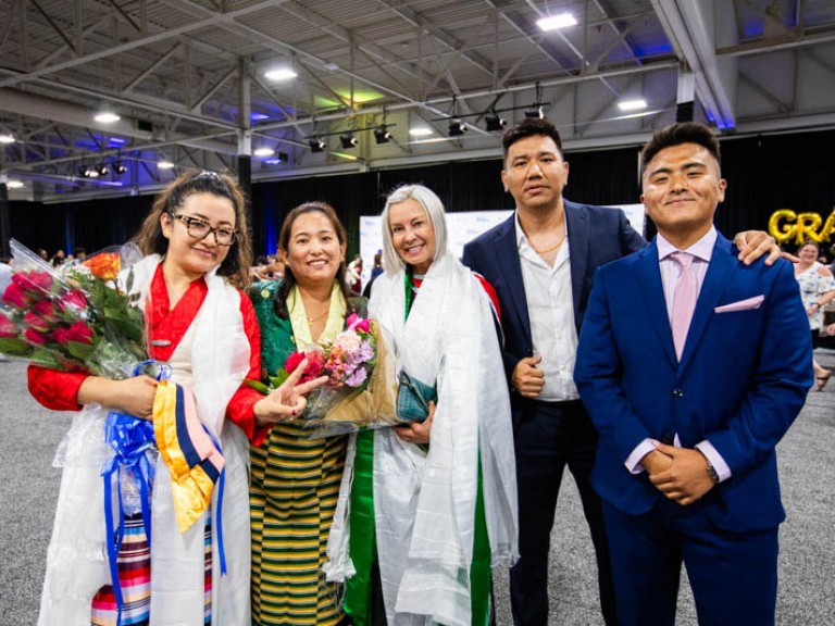 Graduate poses with family members