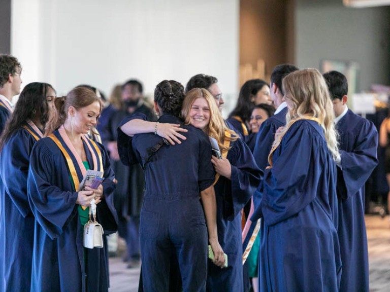 Graduate hugging someone