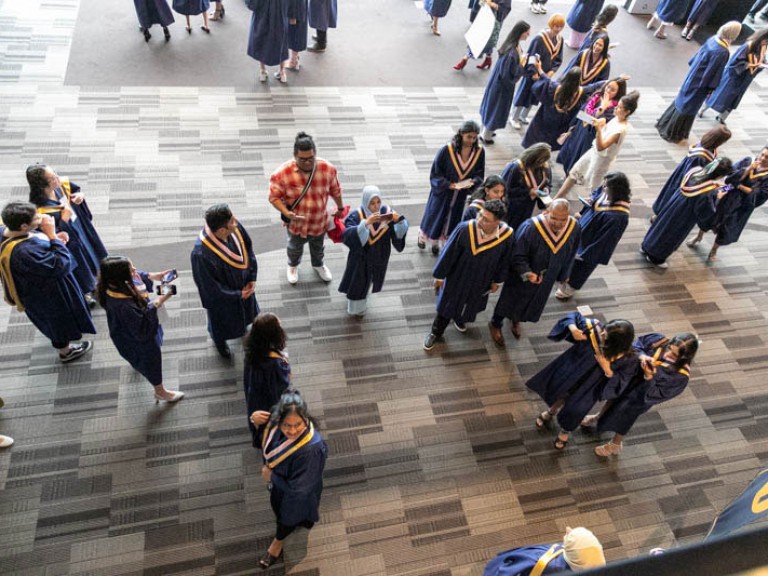 Bird's eye view photo of graduates mingling in the reception area