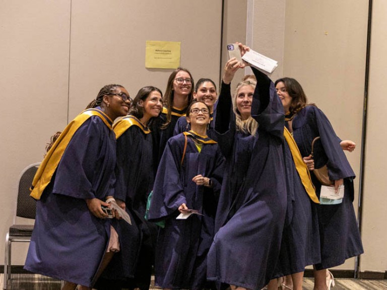 Group of graduates take a selfie together