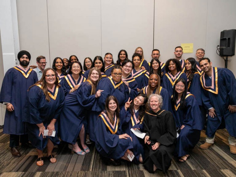 Large group of graduates pose for camera