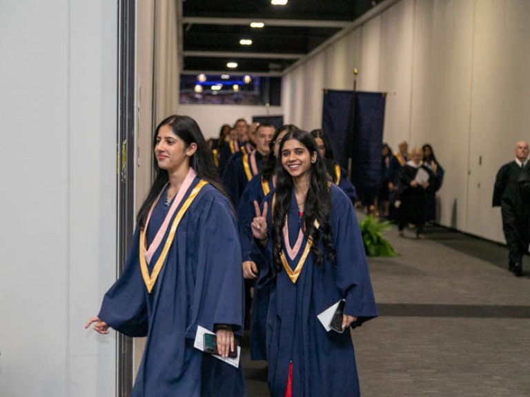 Graduates proceeding in line