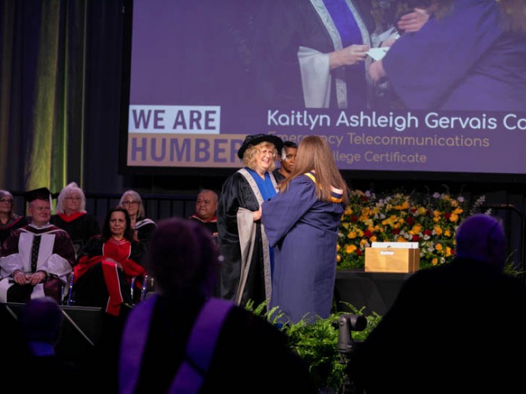 Graduate meets Humber president on stage