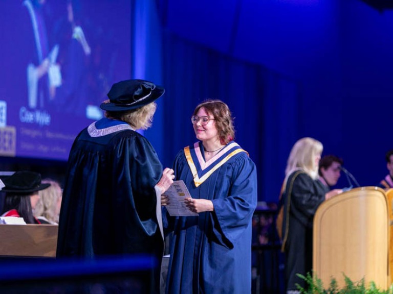 Graduate receives their certificate from Humber president