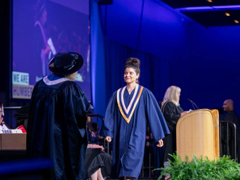 Graduate crosses stage