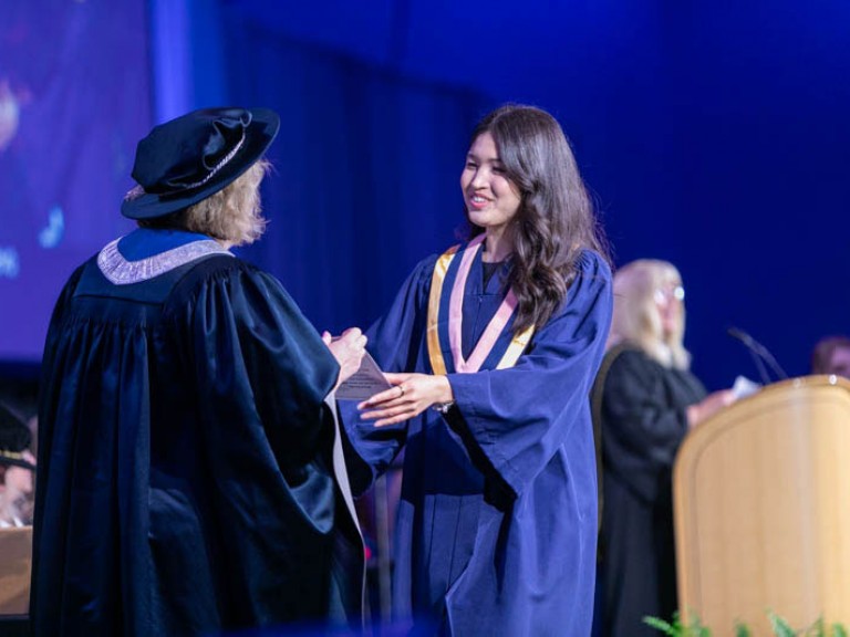 Graduate receives their certificate from Humber president