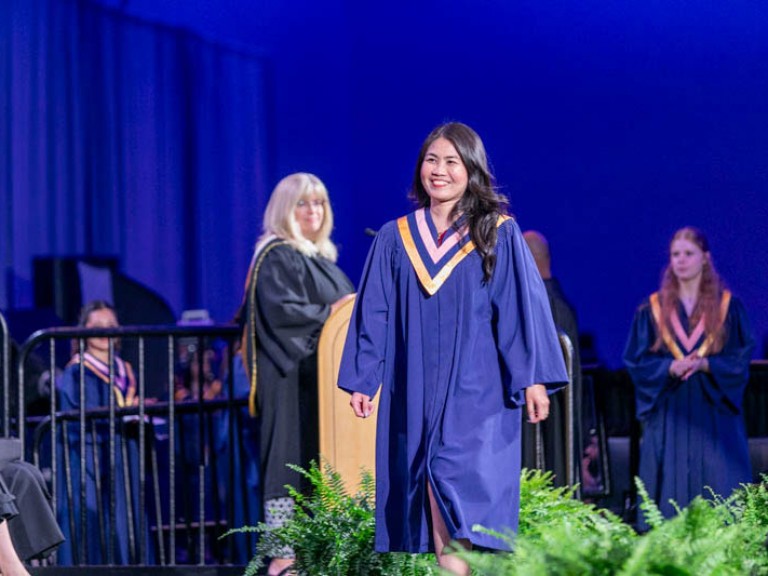 Graduate crosses stage