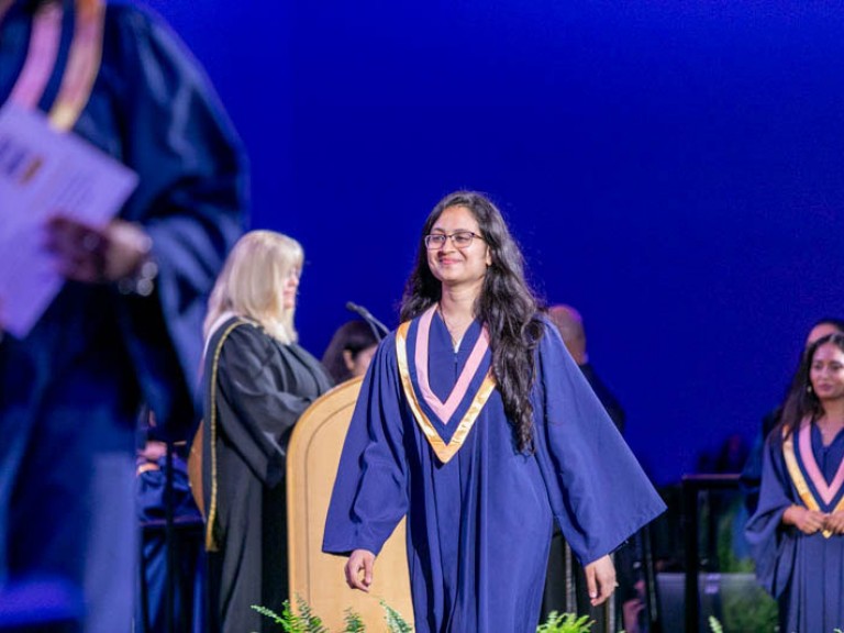 Graduate crosses stage