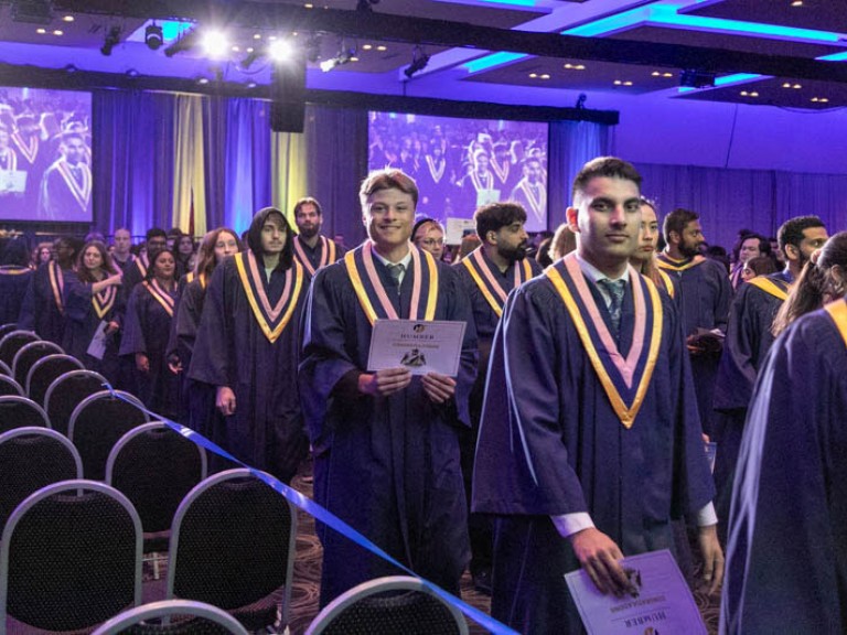 Graduates leave ceremony hall
