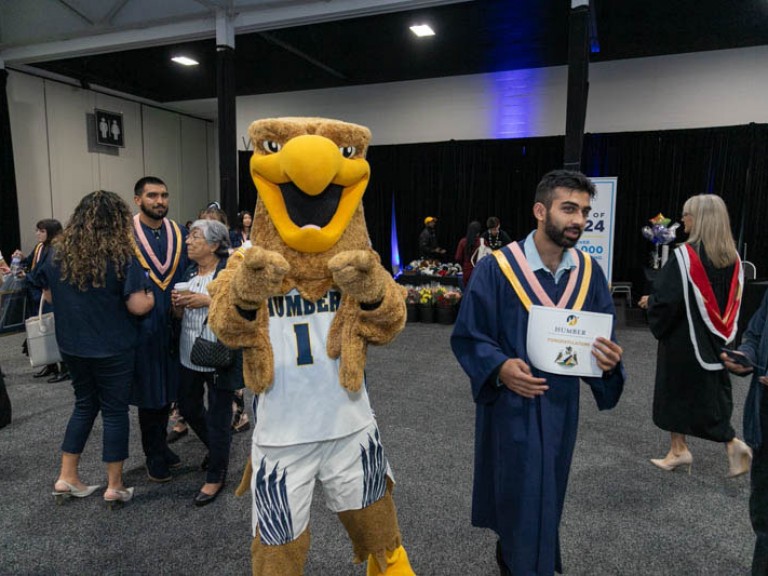 Humber mascot points at camera