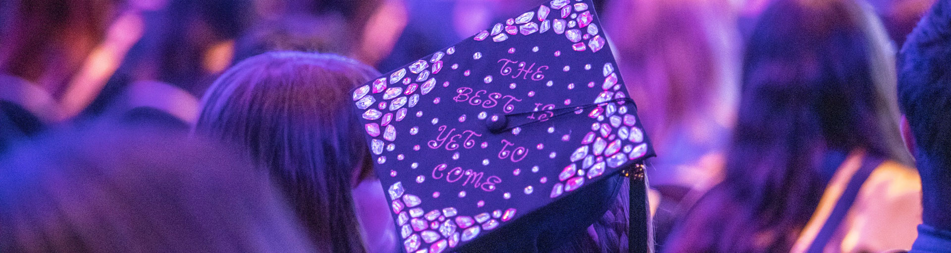 person wearing graduation cap that reads: the best is yet to come