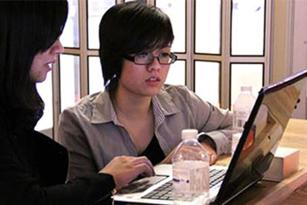 2 students looking at computer