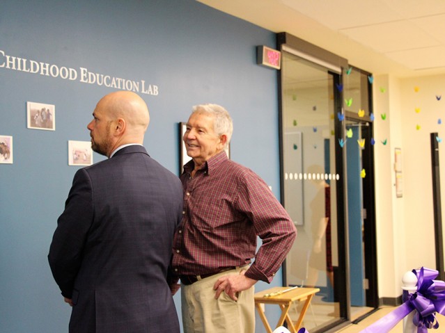 Two men looking at the wall