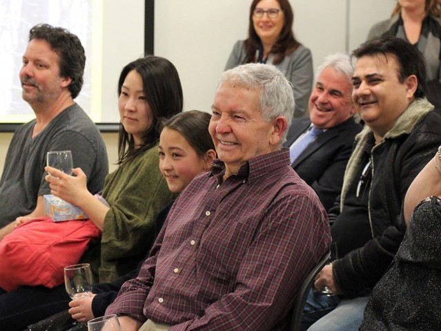 adience listening to the speaker and smiling