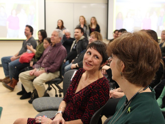 two women in the audience speaking to each other