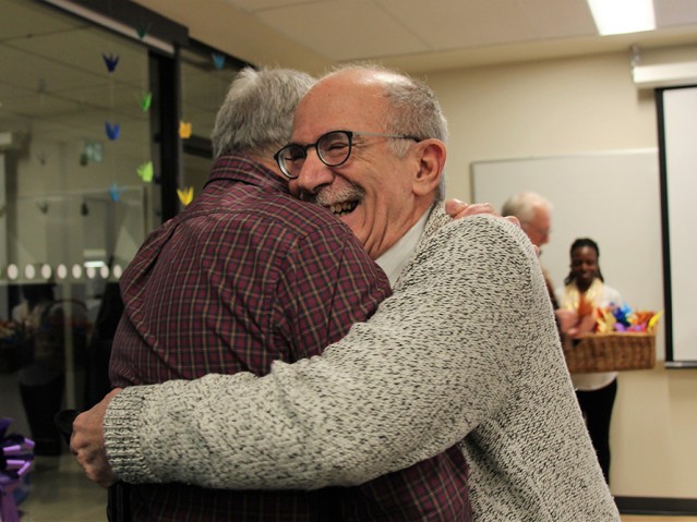 two persons hugging each other with a big smile on their face