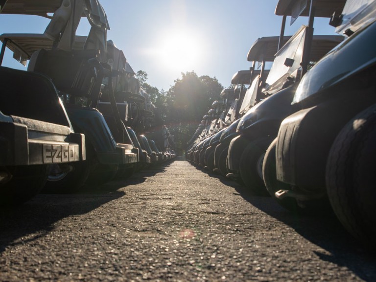 Closeup pavement between golf cart wheels