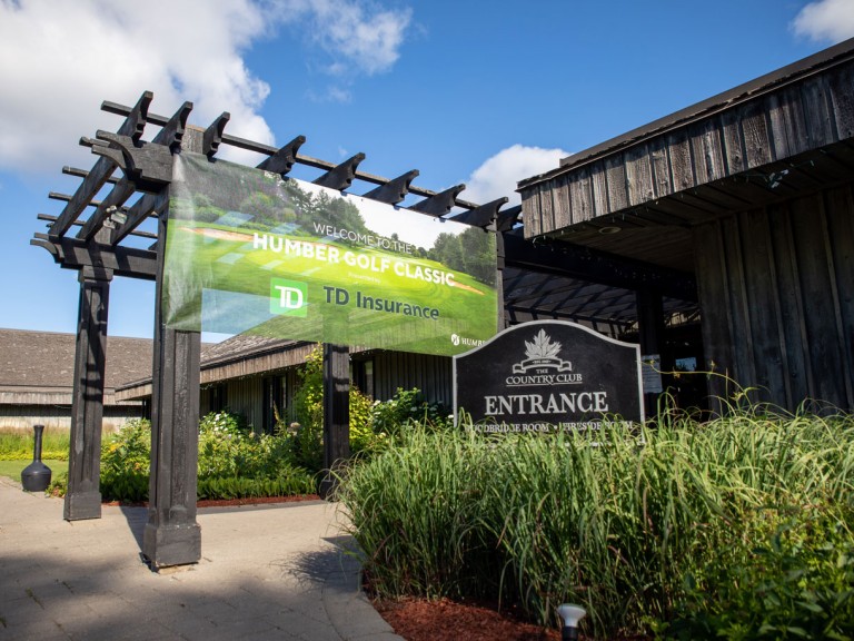 Entrance to country club with Humber banner