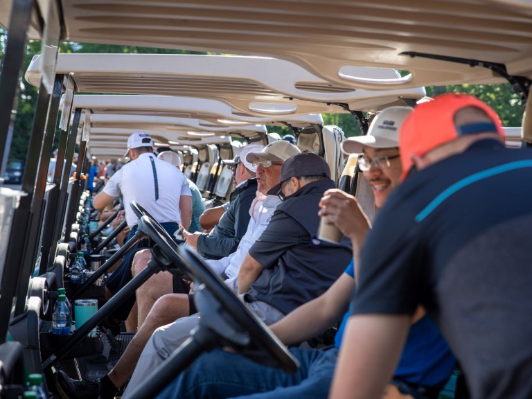 People sitting in golf carts
