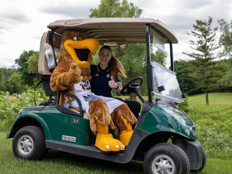 Humber mascot with another person in golf cart