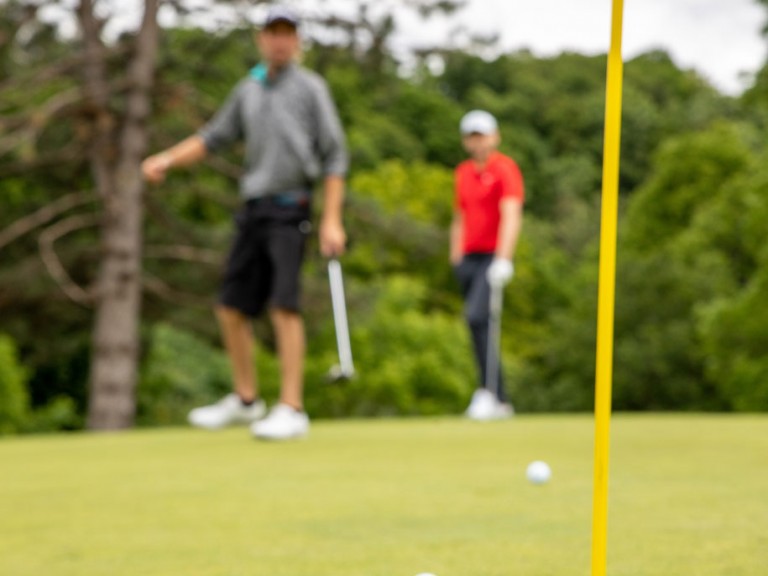 Two golf balls near hole