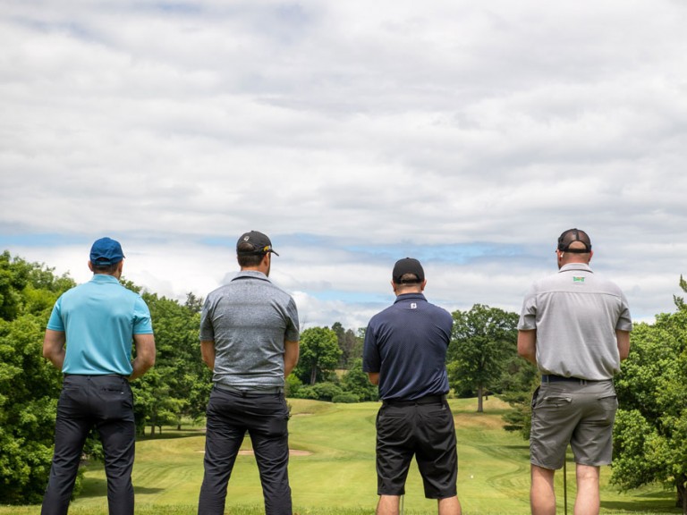 Four people with their backs towards the camera